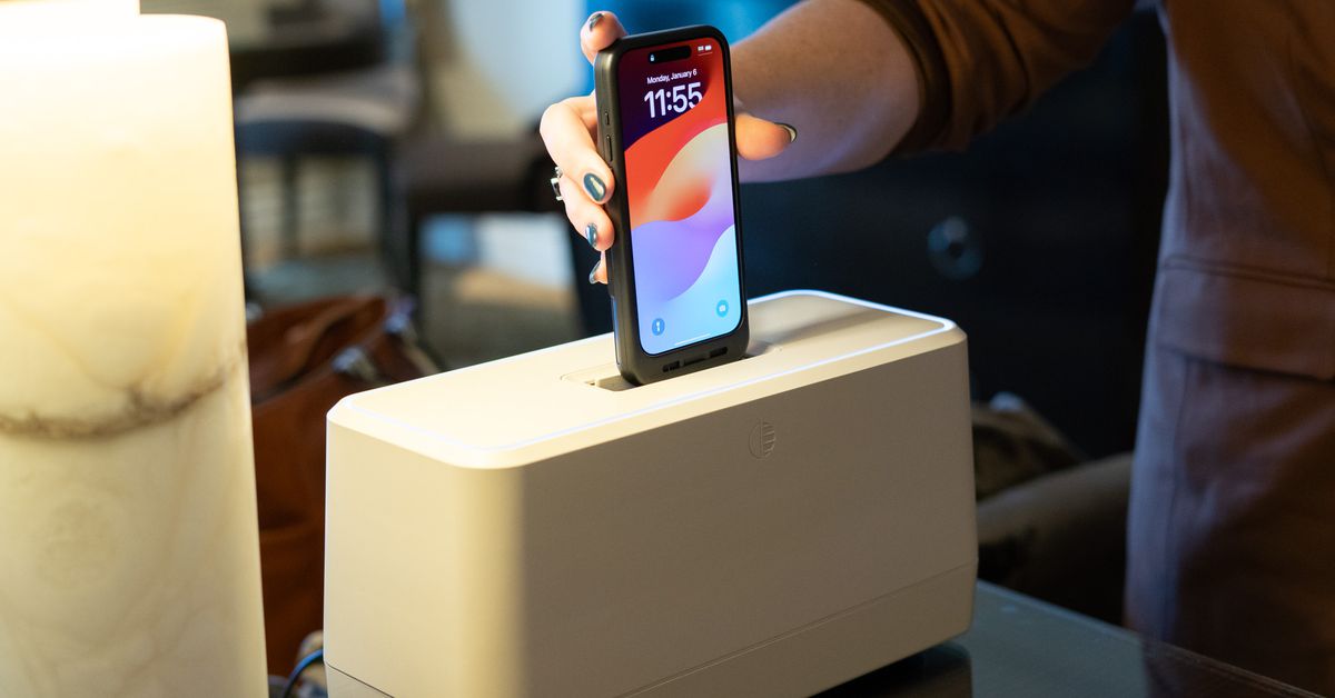 Image of the Swippitt hub resembling a toaster, showcasing its sleek design with LED lights that change color. Compatible with iPhone 15 and 16, using external battery phone cases.